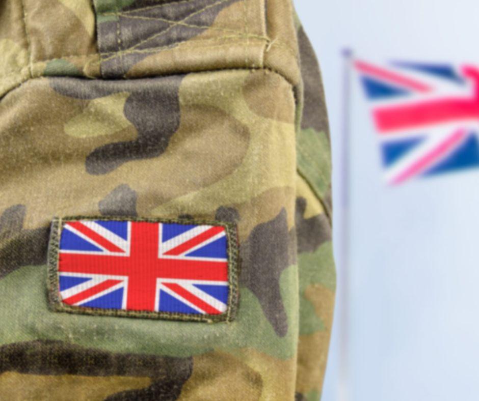 Soldier in uniform with union jack badge on