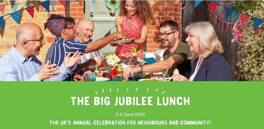 People at a street party in the sun sharing food, caption The Big Jubilee Lunch, 2 to 5 June 2022, The UK's annual celebration for neighbours and community!