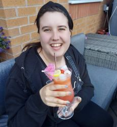 Heather drinking a cocktail