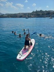 Heather on a paddle board in Greece