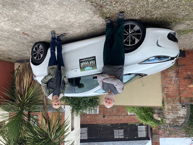 Two members of Leominster Car Share stand next to the club's new Renault Zoe electric car