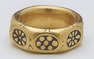 A unique gold octagonal finger ring dated to the 9th century with black niello rosette and flower motifs on each of the eight facets. It is decorated with in the Anglo Saxon &#039;Trewhiddle&#039; style.