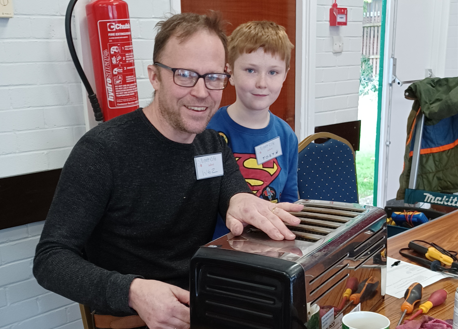 Watched by his son, Wes is one of a number of volunteers at Ledbury’s repair café.