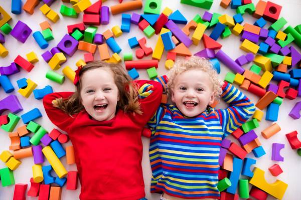 Children laughing in colourful bricks